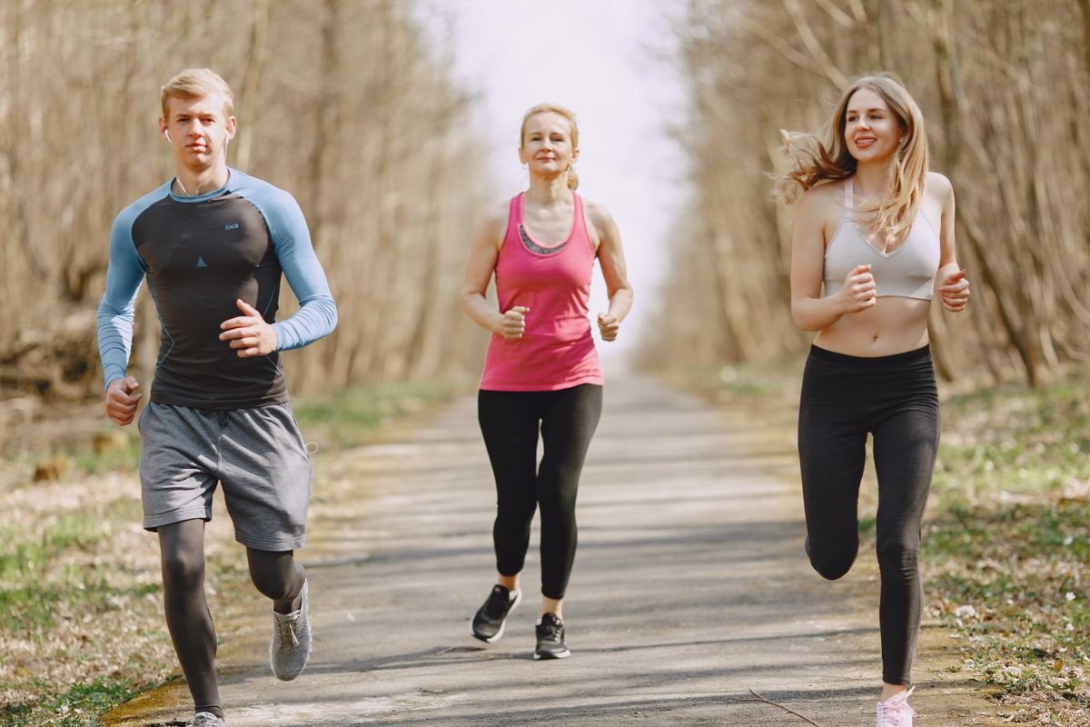 People jogging outdoors, lungs and heart working together during cardio exercise