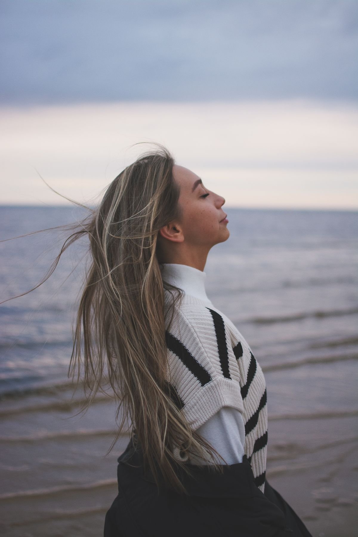 Woman breathing fresh air outdoors, supporting lung and heart health